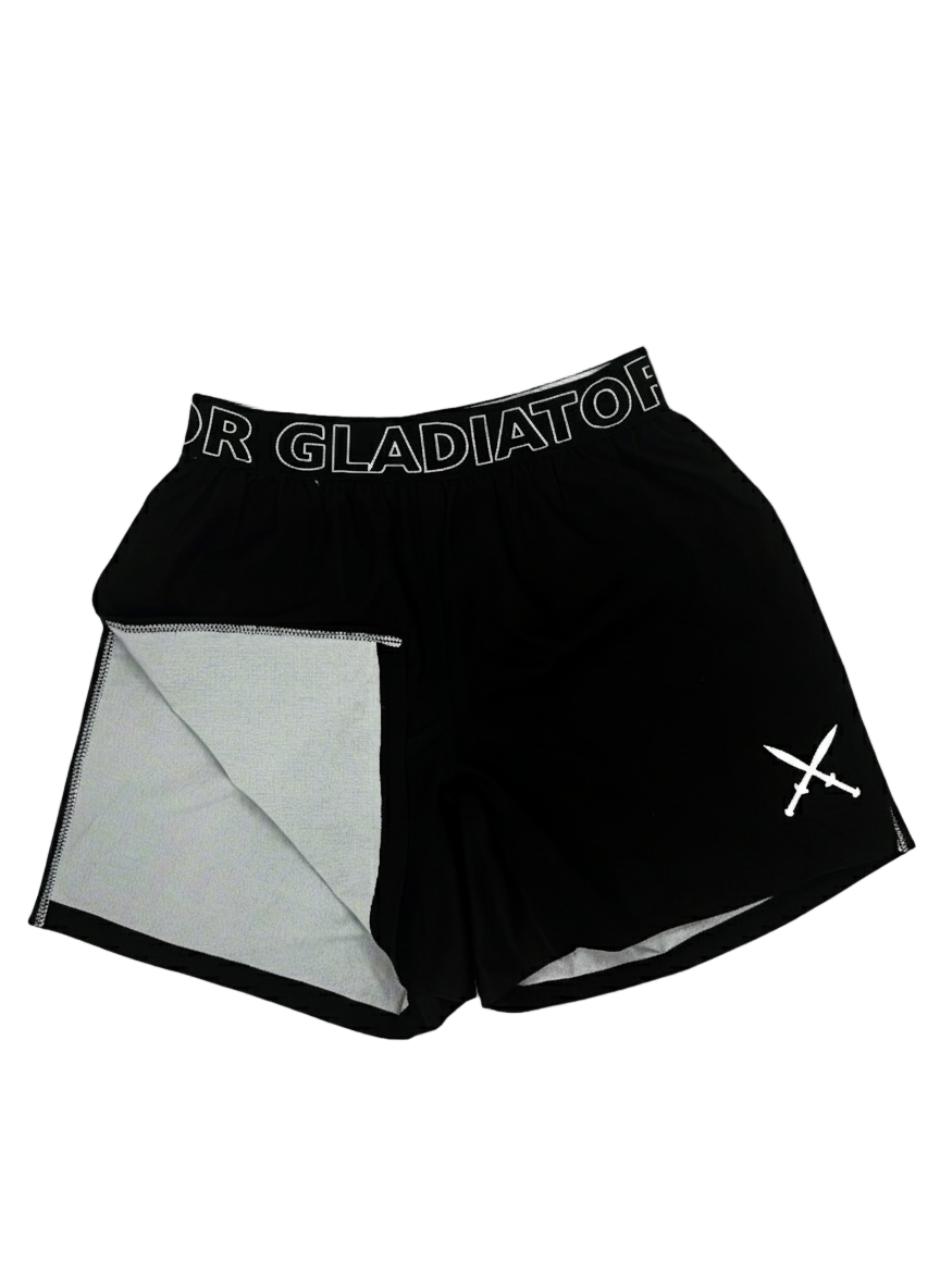 Black athletic shorts with mesh lining and 'Gladiator' branding on a light gray background